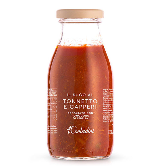 Jar of tomato sauce with a wooden lid on a white background