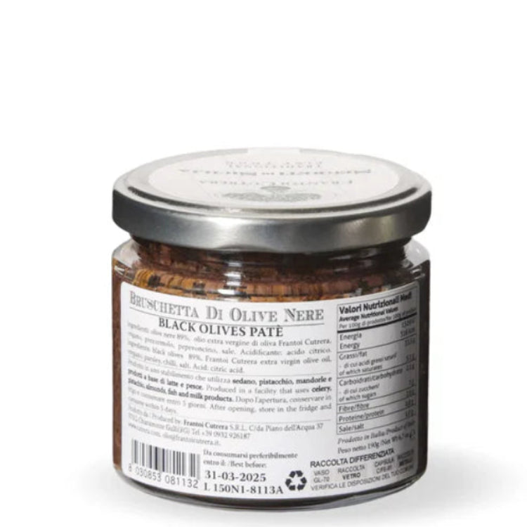 Jar of black olive pesto on a white background