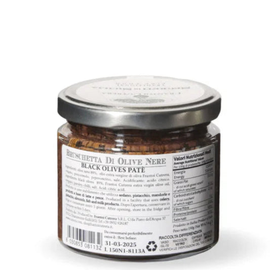 Jar of black olive pesto on a white background