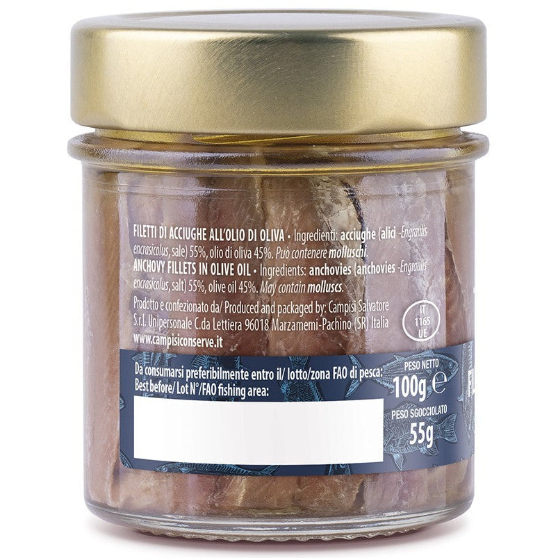 Glass jar with gold lid containing food on a white background